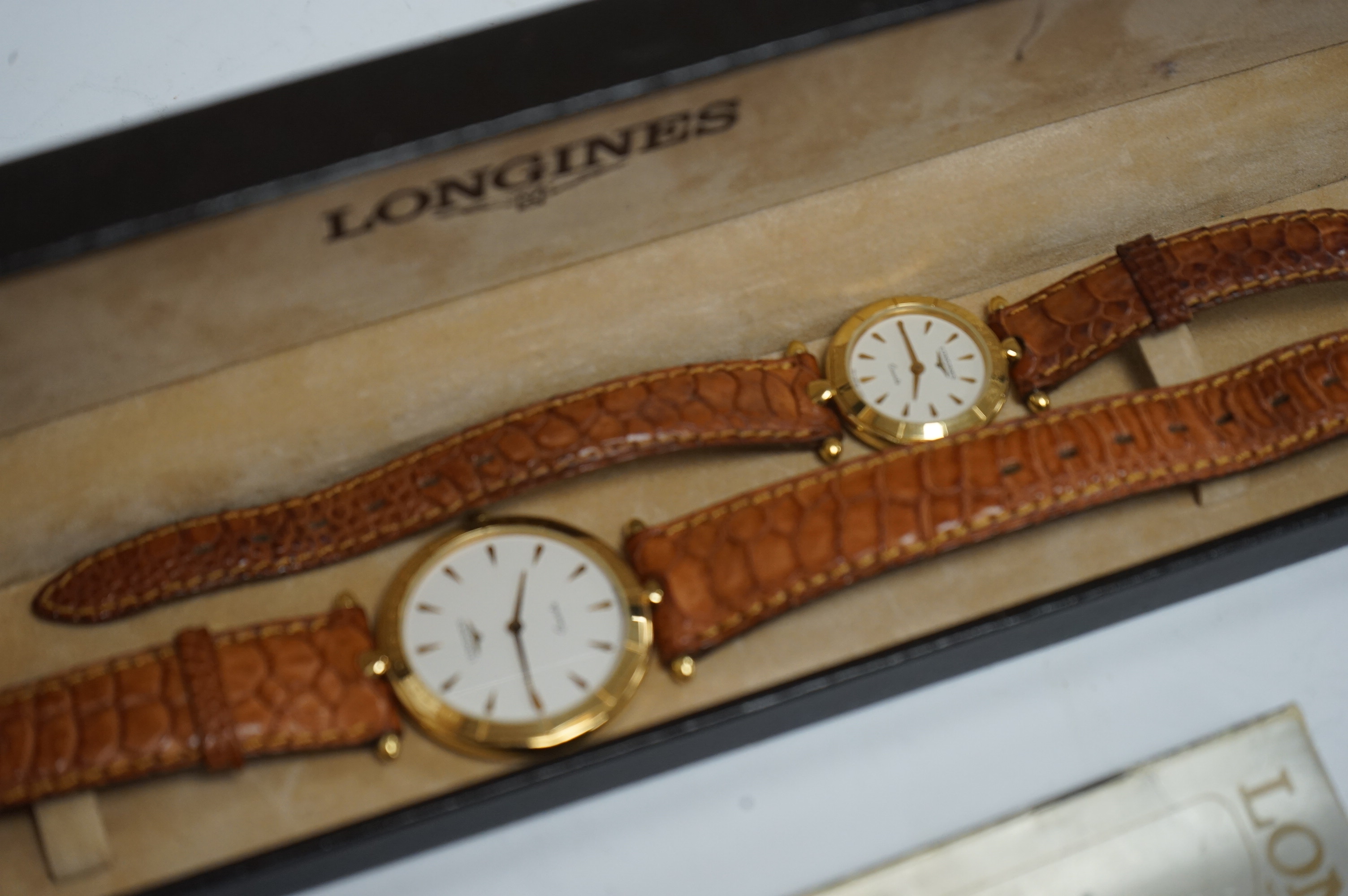 A lady's and gentleman's recent steel and gold plated Longines for Mercedes Benz quartz wrist watches, with baton numerals, on Longines leather straps, case diameters 31mm and 23mm, with single box. Condition - fair to g